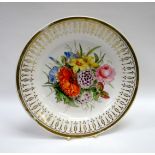 A SWANSEA PORCELAIN PLATE decorated with a large spray of flowers to the interior and with gilding