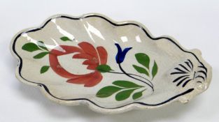 A LLANELLY POTTERY DISH of acorn-leaf shape, painted with a stylised flowers with leaves,