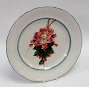 A LLANELLY POTTERY PLATE painted with wild-roses to the centre within green borders, unmarked, 22cms