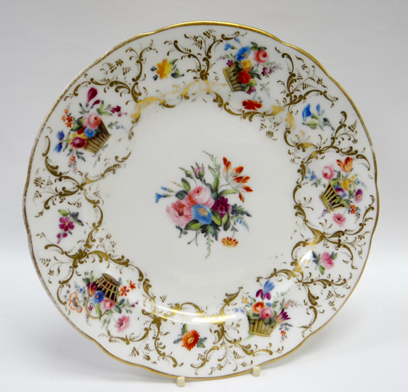 A NANTGARW PORCELAIN PLATE of slightly lobed form and painted with an interior of flowers to the