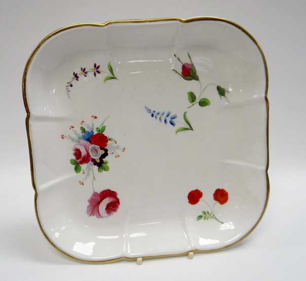 A SWANSEA PORCELAIN SQUARE DISH of rounded and fluted form with gilded rim and painted with