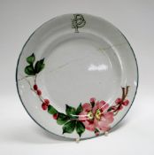 A LLANELLY POTTERY MONOGRAMMED PLATE painted with wild-roses, the border with stylised monogram ‘DP’