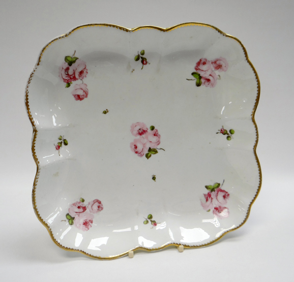 A SWANSEA PORCELAIN SQUARE DISH of rounded and fluted form with gilded rim and painted with pink