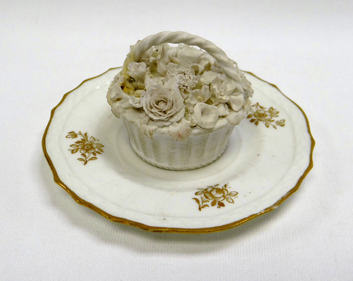 RARE SWANSEA BISCUIT PORCELAIN BASKET of circular form with moulded flowers, 4.6cms high; together