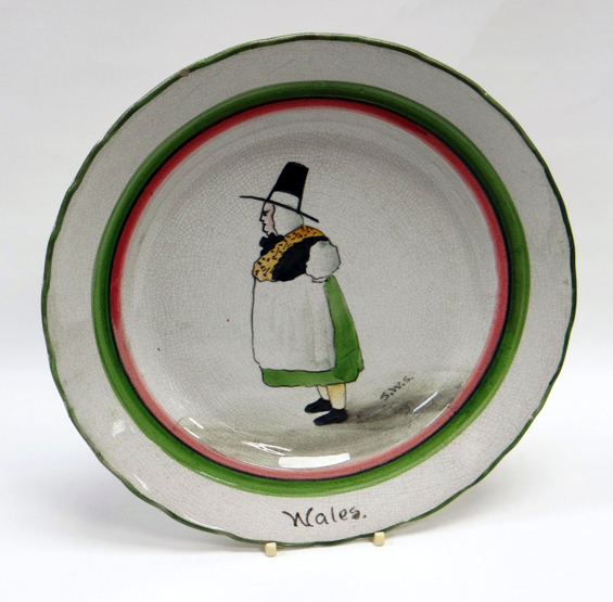 A LLANELLY PLATE SIGNED BY SHUFFLEBOTHAM of circular form with green and red trim, painted with a