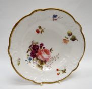 A NANTGARW PORCELAIN SHALLOW DISH of alternate lobed form, the border moulded with flowers, scrolls