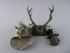 A VICTORIAN CAST IRON PEN REST in the form of a pair of stag antlers, mounted on a rectangular base,