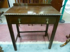 A MAHOGANY SINGLE DRAWER SIDE TABLE, early 20th Century with shallow railback and moulded edge