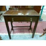 A MAHOGANY SINGLE DRAWER SIDE TABLE, early 20th Century with shallow railback and moulded edge