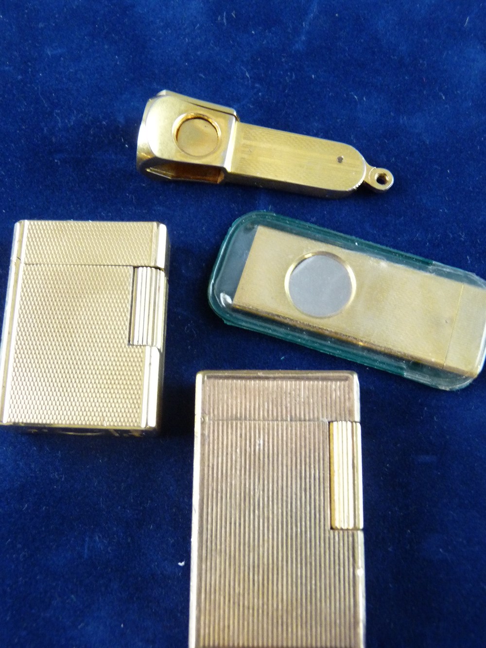 TWO DUPONT, PARIS VINTAGE PETROL LIGHTERS and two gilt metal Solingen cigar cutters