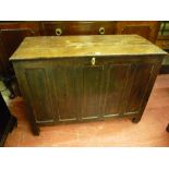 AN ANTIQUE OAK LIDDED COFFER, early to mid 19th Century with lift-off three plank top, interior