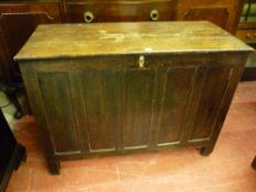 AN ANTIQUE OAK LIDDED COFFER, early to mid 19th Century with lift-off three plank top, interior