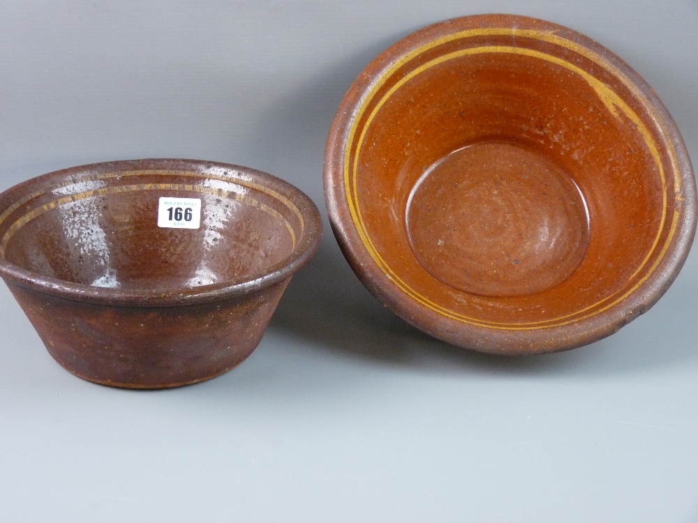 TWO BUCKLEY POTTERY BOWLS, Welsh terracotta semi-glazed with slipware interior bands, 24 cms