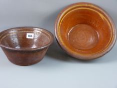 TWO BUCKLEY POTTERY BOWLS, Welsh terracotta semi-glazed with slipware interior bands, 24 cms