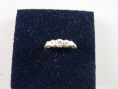 AN EIGHTEEN CARAT GOLD DIAMOND RING with a band of five small graduated diamonds and with tiny