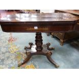 A REGENCY ROSEWOOD AND BRASS INLAID FOLDOVER TEA TABLE on a turned column quatrefoil base with