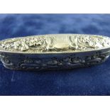 A HALLMARKED SILVER PILL BOX in elongated oval form with embossed floral decoration and central