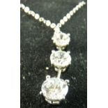 A FOURTEEN CARAT GOLD NECK CHAIN with three graduated cz drops