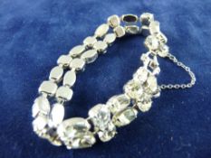 A WHITE METAL BRACELET of oval and round cut czs, total 19 grms