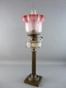 A DUPLEX VICTORIAN OIL LAMP on a brass square base and reeded column, facet cut glass font, brass