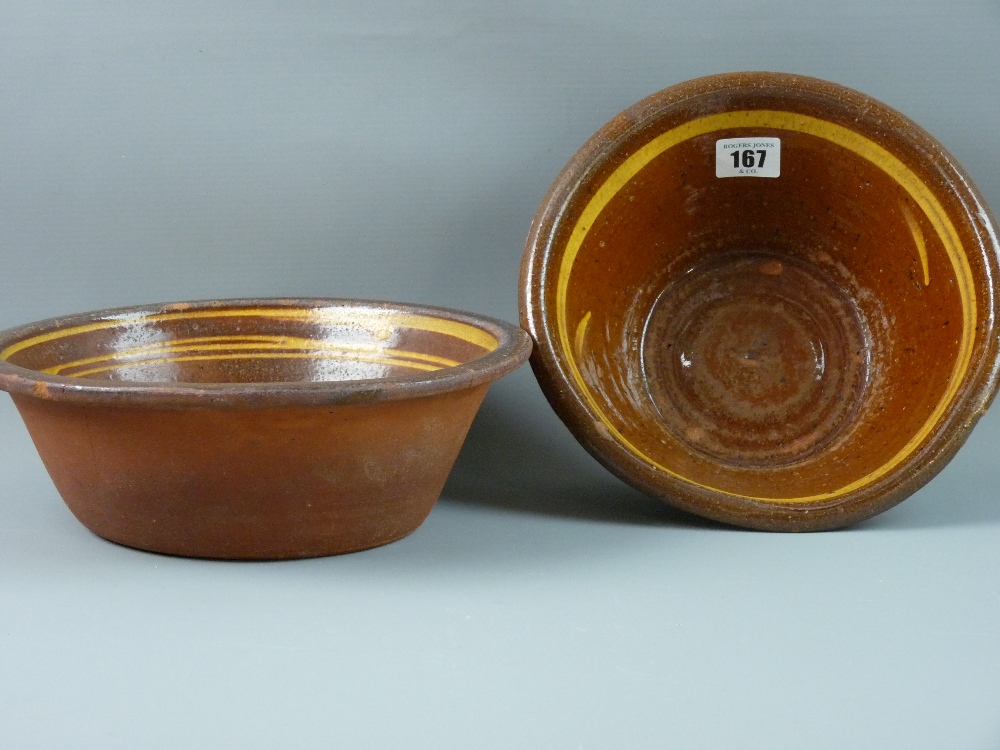 TWO BUCKLEY POTTERY BOWLS, Welsh terracotta semi-glazed with slipware bands to the interiors, 23 cms