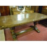 AN OAK REFECTORY TABLE with rectangular top on substantial bulbous supports on shaped feet with