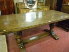 AN OAK REFECTORY TABLE with rectangular top on substantial bulbous supports on shaped feet with