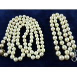 A LONG NECKLACE OF UNIFORM CULTURED PEARLS, 80 cms long with nine carat gold diamond and sapphire