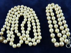 A LONG NECKLACE OF UNIFORM CULTURED PEARLS, 80 cms long with nine carat gold diamond and sapphire