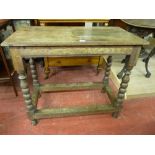 AN EARLY OAK SIDE TABLE having a moulded edge rectangular top on block and bobbin turned supports