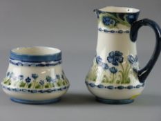 A MOORCROFT MACINTYRE JUG AND BOWL with tube lined blue and green floral pattern on a white