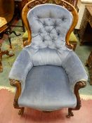 A VICTORIAN WALNUT BUTTON BACKED ARMCHAIR, quality carved with pierced top rail, swept arms and