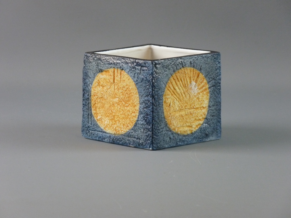 A TROIKA POTTERY SQUARE SECTION VASE, each side with a central orange disc with blue surround and