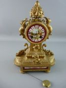 A FRENCH GILT METAL AND PORCELAIN MANTEL CLOCK typically modelled with ormolu mounts, the pendulum
