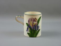 A WEMYSS WARE MUG with hand painted 'Iris' pattern, green rim and shaped decorated handle, impressed