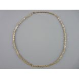 A NINE CARAT GOLD NECK CHAIN of small triple links, 3 grms