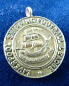 A NINE CARAT GOLD CIRCULAR SOCCER PENDANT - 'The Liverpool Shipping Football League, Melly Cup