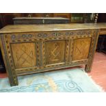 AN ANTIQUE OAK INLAID COFFER, the two plank top with iron pin hinges, leaf and disc frieze