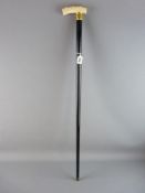 A VICTORIAN IVORY HANDLED AND EBONY GENT'S WALKING CANE with gold plated collar, 87 cms long