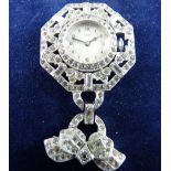 A WHITE METAL DIAMANTE HEXAGONAL FRAMED PENDANT FOB WATCH marked 'Regalis', heavily encrusted with