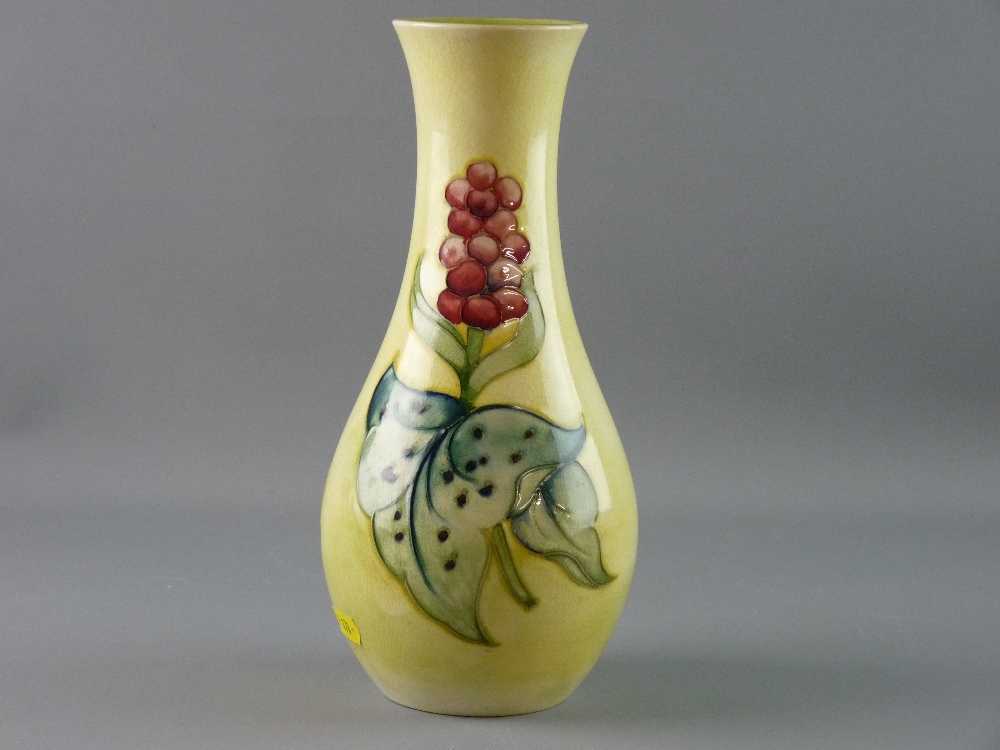 A MOORCROFT ARUM LILY VASE, 28 cms high decorated on a yellow ground with green interior,