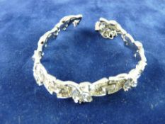 A WHITE METAL BACKED CZ BRACELET, the stones in leaf form with tiny intervening stones, 25 grms