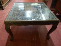 A 20th CENTURY CARVED INDIAN HARDWOOD COFFEE TABLE, circular centre top with excellent leaf carved