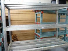 *A STAINLESS STEEL FOUR SHELF STORAGE RACK, 1.2 metres long