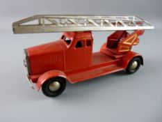 A TINPLATE CLOCKWORK FIRE ENGINE in red livery with added gold highlighting and single top ladder,