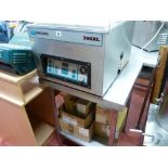 *A HENKELMAN 200XL STAINLESS STEEL VACUUM PACKER with quantity of bags on a stainless steel two tier