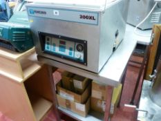 *A HENKELMAN 200XL STAINLESS STEEL VACUUM PACKER with quantity of bags on a stainless steel two tier