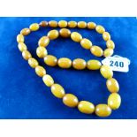 A BUTTERSCOTCH AMBER NECKLACE, single row graduated set, 64 cms approximate length, 2 cms the