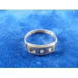 A FIFTEEN CARAT GOLD DRESS RING with three tiny czs, 1.7 grms total