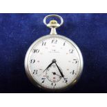 AN LIP TYPE COURANT OPEN FACED POCKET WATCH, the white metal case back with repousse style